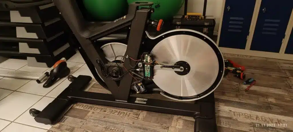 Exercise bike with side panel removed for service access