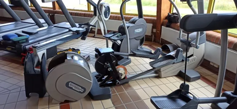 Technician repairing a professional elliptical machine
