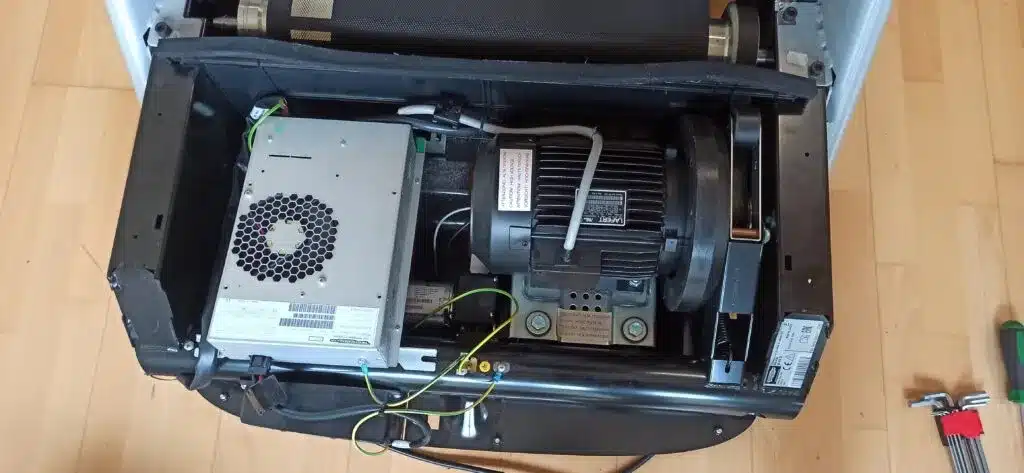 Treadmill opened for visual inspection of the motor and controller