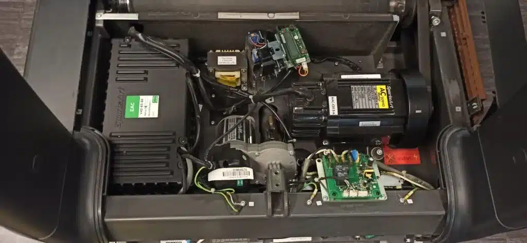 Internal components of treadmill exposed for service and testing
