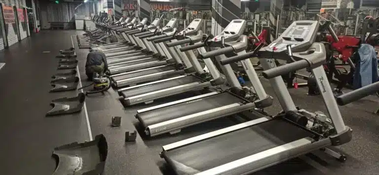 Preventive maintenance on a commercial treadmill by a technician